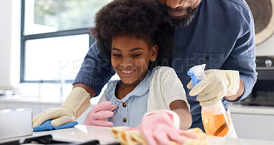 Happy black girl, father and cleaning in kitchen together for hygiene, housekeeping or bonding in chores at home. African dad and child wiping surface, furniture or table for germ or bacteria removal