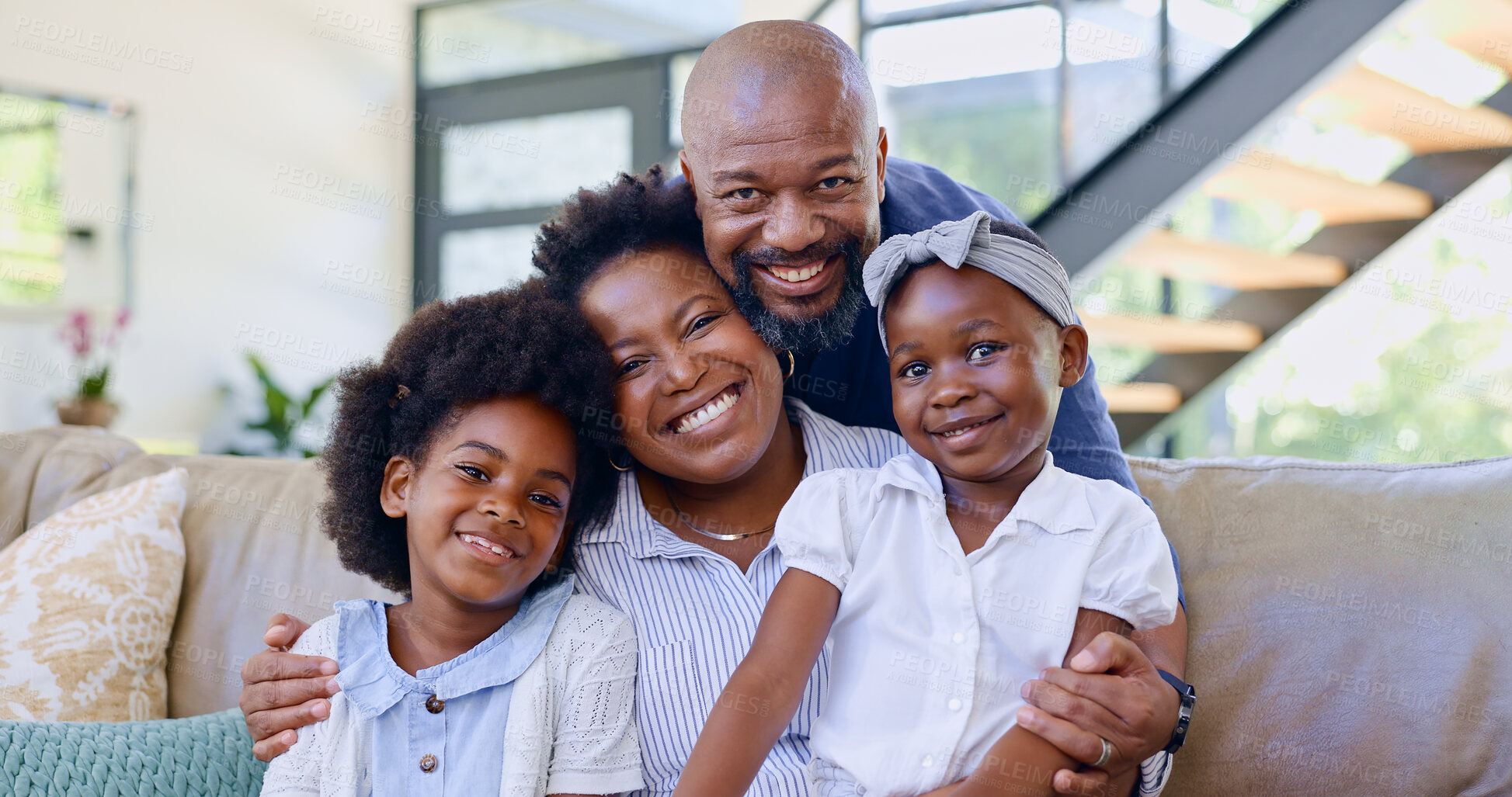 Buy stock photo Portrait, happy family and children with hug on sofa in living room for bonding, security and support. Black man, woman and girl with embrace, love and together with care for relationship in home