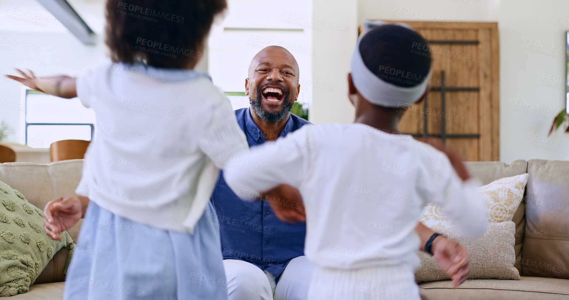 Buy stock photo Running, children and father on a sofa with hug, happy and playing in their home together. Kids, energy and excited black family in living room embrace, security and support, games or bonding love