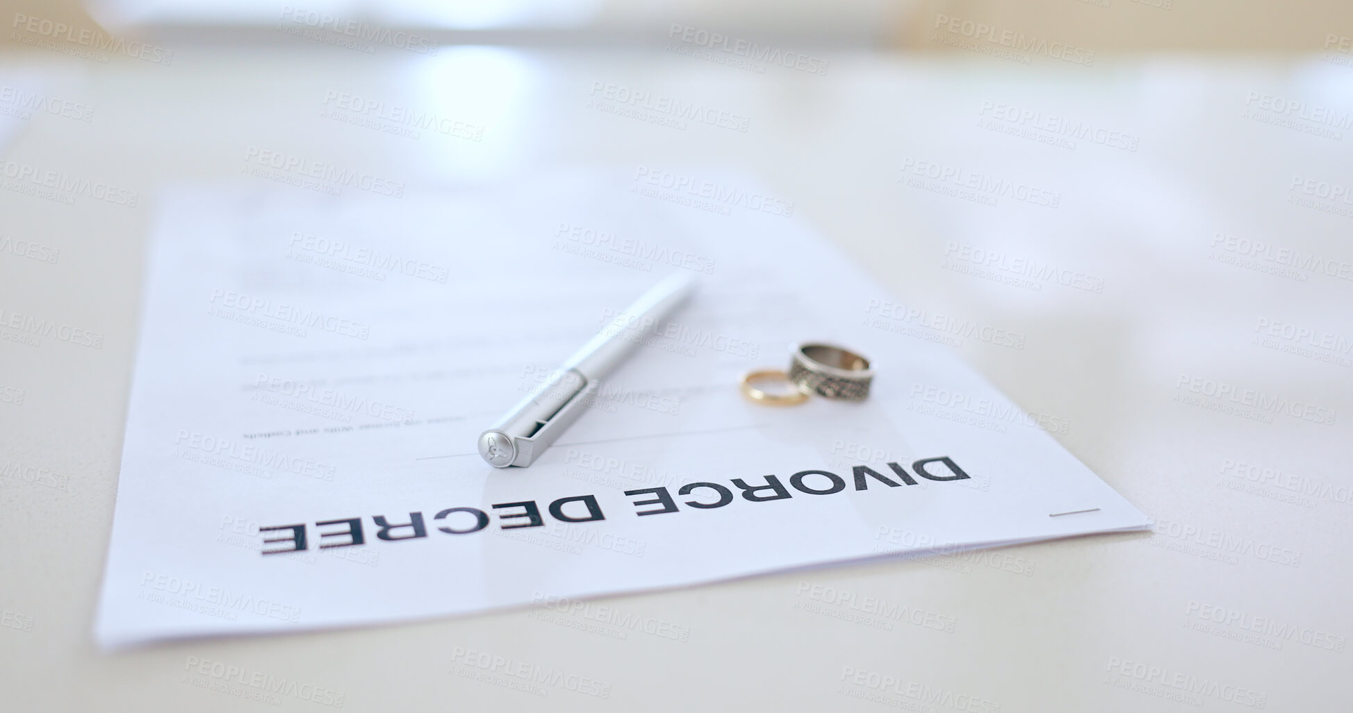 Buy stock photo Divorce, contract and pen with wedding in office for signature, decision and break up of marriage. Closeup, document or legal paperwork and rings with trouble, problem or conflict in relationship