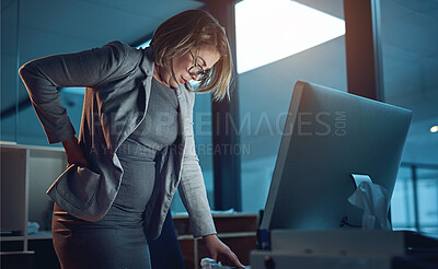 Buy stock photo Cropped shot of a businesswoman suffering from backache while working late in the office
