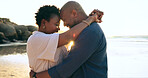 Couple, hug and happy on beach with love, bonding and sunset for holiday, vacation and relationship. Black people, man or woman with embrace, smile and romance by ocean or sea for travel or adventure
