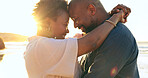 Couple, hug or smile on beach with love, bonding and sunlight for holiday, vacation or relationship. Black people, man or woman with embrace, happy and romance by ocean or sea for travel or adventure