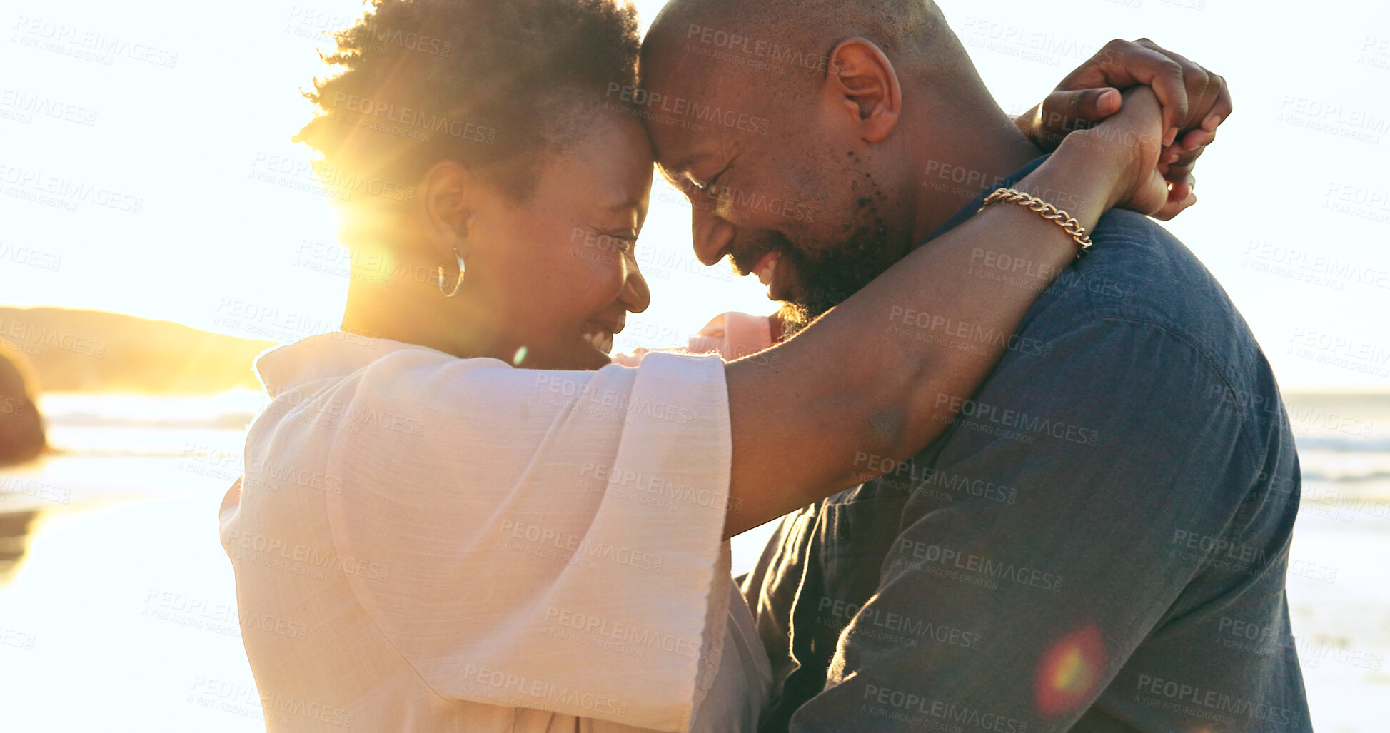 Buy stock photo Couple, hug or smile on beach with love, bonding and sunlight for holiday, vacation or relationship. Black people, man or woman with embrace, happy and romance by ocean or sea for travel or adventure