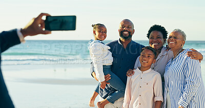 Buy stock photo Phone, family picture and generations at beach, bonding and love with hug, support and ocean. People, happiness and relaxing on weekend, nature and care on vacation, smile and smartphone on holiday