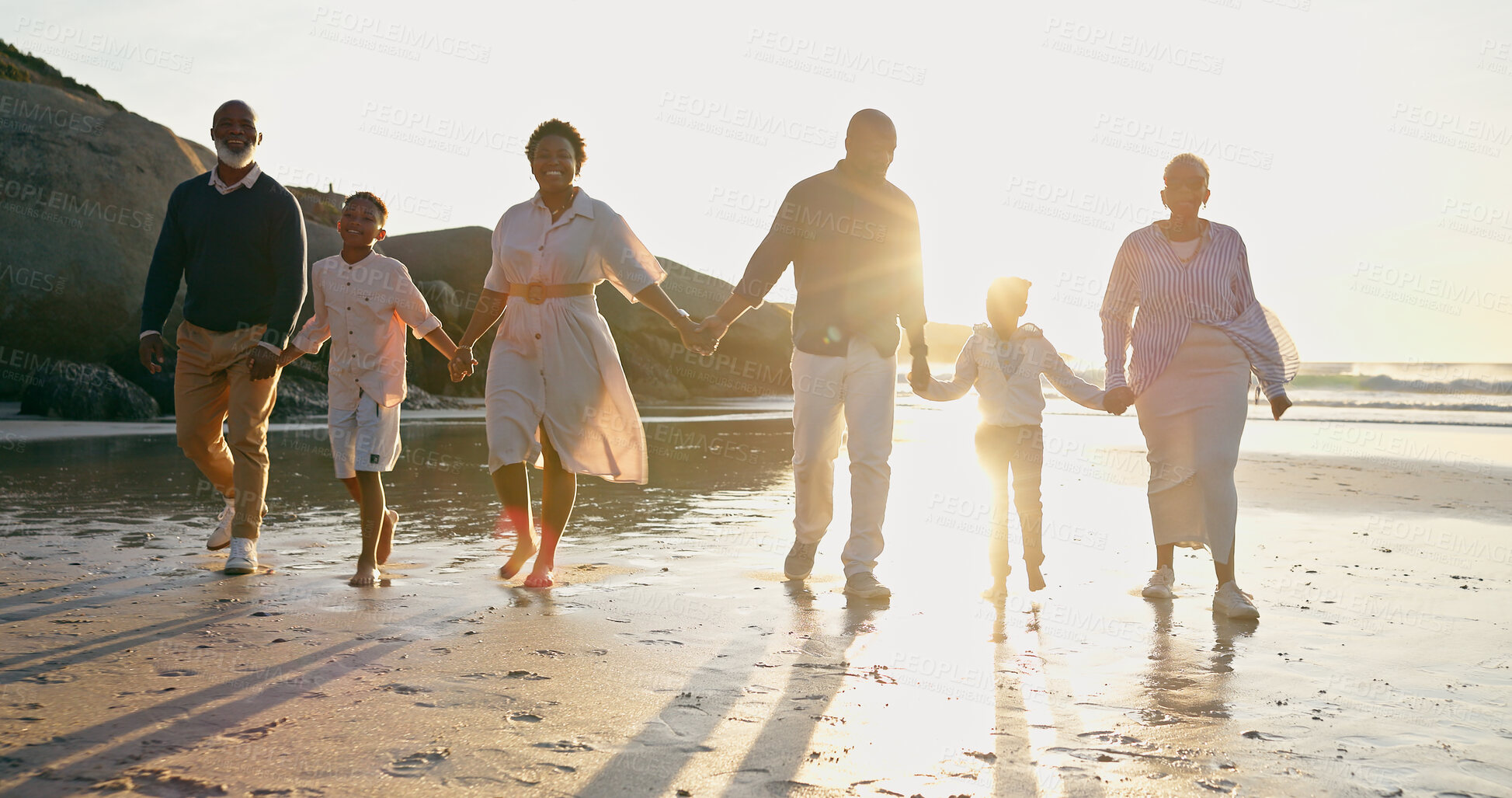 Buy stock photo Family, fun and holding hands at beach, support and unity or trust, ocean and solidarity or care. Happy black people, sea and love or joy, bonding or water on vacation, holiday and laughing at sunset
