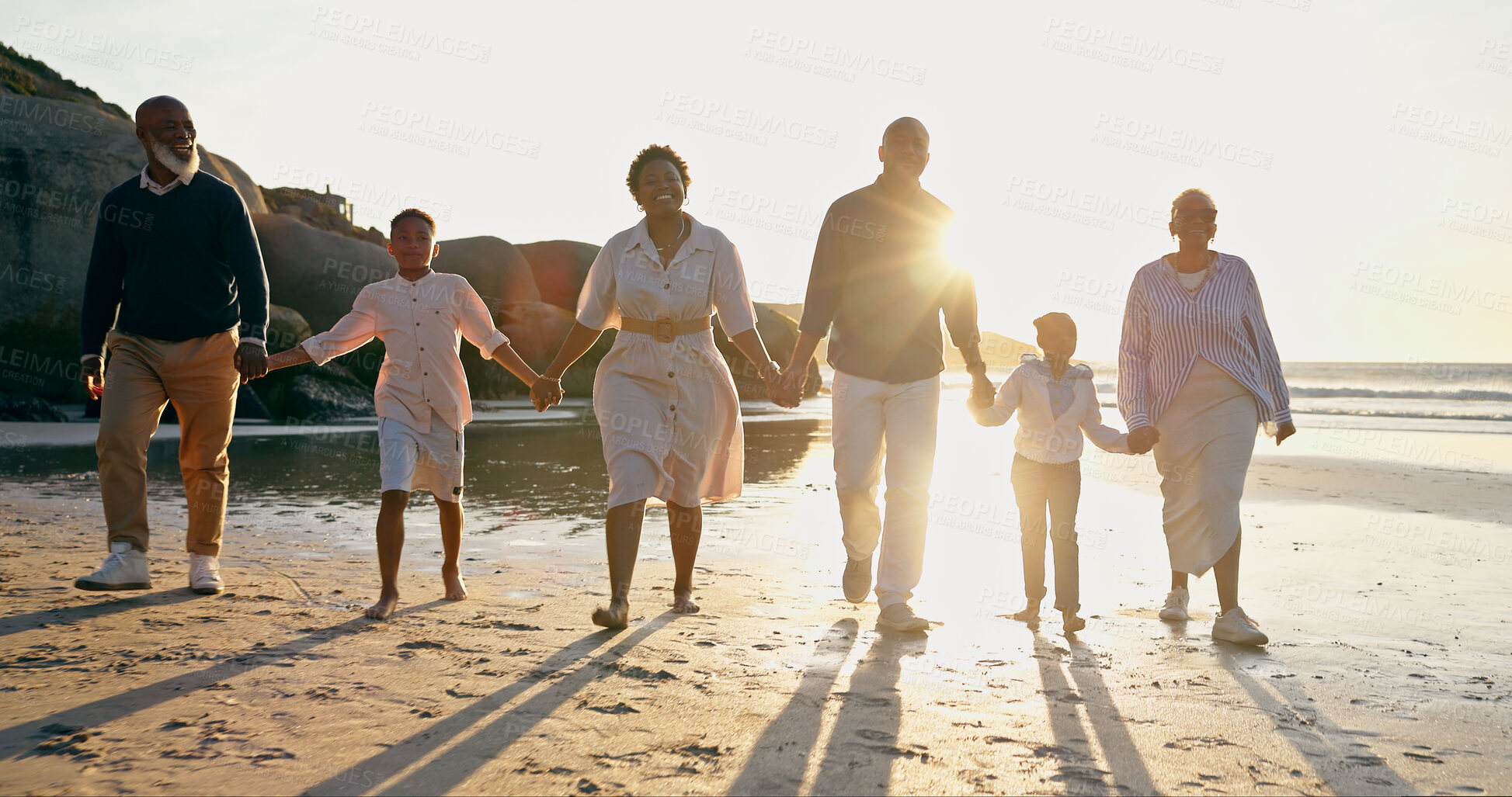 Buy stock photo Family, fun and holding hands at beach, smile and support or trust, ocean and solidarity or care. Happy black people, sea and love or joy, bonding and water on vacation, holiday and laughing in sun