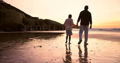 Father, son and holding hands at beach, sunset and support or trust, ocean and solidarity or care. Black family, sea and love or fatherhood, bonding and water on vacation, holiday and peace at dusk