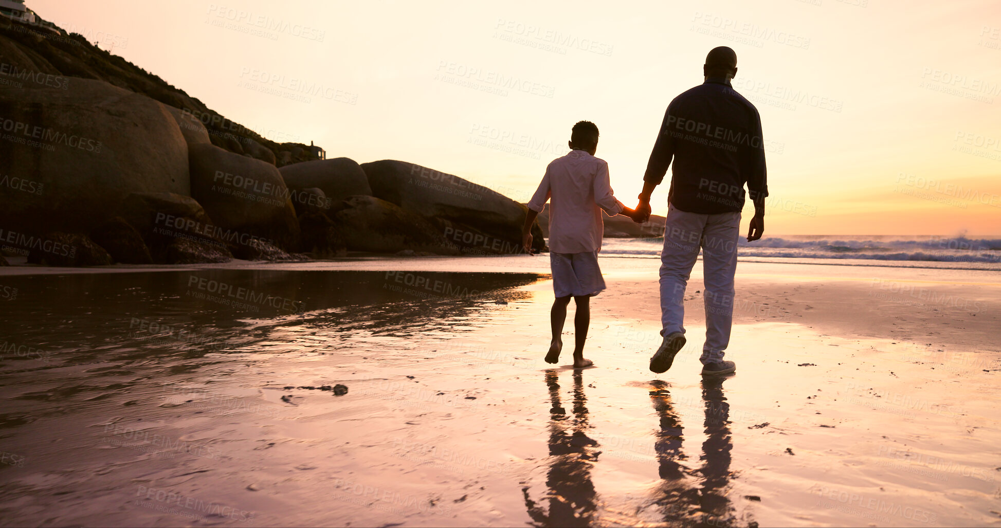 Buy stock photo Father, son and holding hands at beach, sunset and support or trust, ocean and solidarity or care. Black family, sea and love or fatherhood, bonding and water on vacation, holiday and peace at dusk