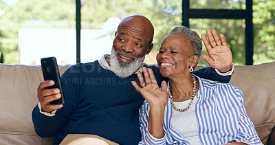 Happy senior couple, video call and smartphone in home for voip communication, social network or chat. African man, woman and wave hello for virtual conversation, mobile contact or talk in retirement