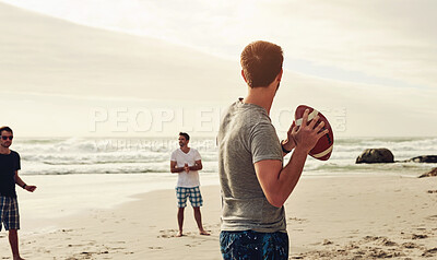 Buy stock photo Shot of a group of happy young friends playing with a ball on the beach