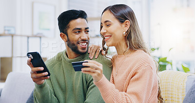 Phone, love and couple with credit card on a sofa for loan, payment or banking in their home. Investment, growth and people with smartphone, app and online shopping, sale or ecommerce sign up choice