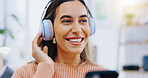 Woman, phone and smile with headphones in home for listening to audio, radio and podcast. Face, happy girl and smartphone for streaming music, media subscription and thinking of sound on mobile app