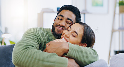 Buy stock photo Happy, hug and couple on a sofa with love, relax and security at home bonding, hanging out or chilling. Smile, support and people in living room with trust, commitment and gratitude, care or romance