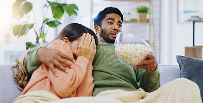 Buy stock photo Fear, jump and couple watching tv on a sofa with popcorn for movie, film or streaming show at home. Omg, television and people hug in living room with cinema snack for scary, horror or spooky series