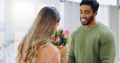 Buy stock photo Couple, bouquet and woman gift in home, roses and smile with care, love or smell for birthday, anniversary or celebration. Man, girl and flowers for present, surprise or bonding with romance in house