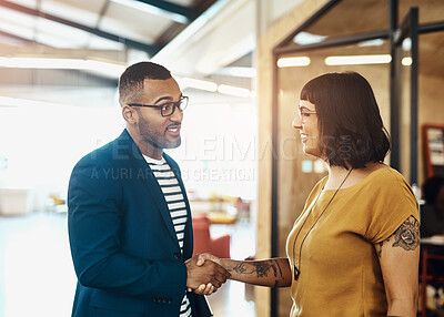 Buy stock photo Shot of two designers shaking hands in an office