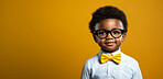 Child, portrait and fashion with yellow bow tie, glasses and smile on mockup banner background. Face, kid and male youth with cool, trendy and confident clothes style on studio space