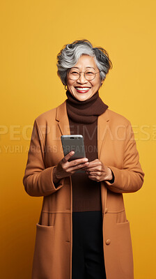 Senior asian woman, phone and glasses in mock-up with device music, social media video or funny meme. Happy pensioner laughing for audio tech, internet post and cellphone in studio with vibrant colour