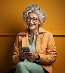 Senior woman, portrait and phone for social media app, internet and website on color background mockup. Face, smile and happy pensioner with mobile technology for influencer blog post in studio