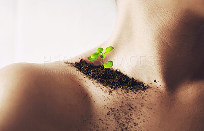 Buy stock photo Shot of an unidentifiable young woman's shoulder with soil and a small seedling on it