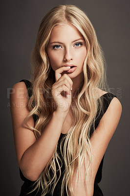 Buy stock photo Beauty, face and portrait of a seductive woman with makeup, cosmetics and long hair in studio. Sexy female aesthetic model with skin glow, luxury skincare and finger in mouth on a grey background
