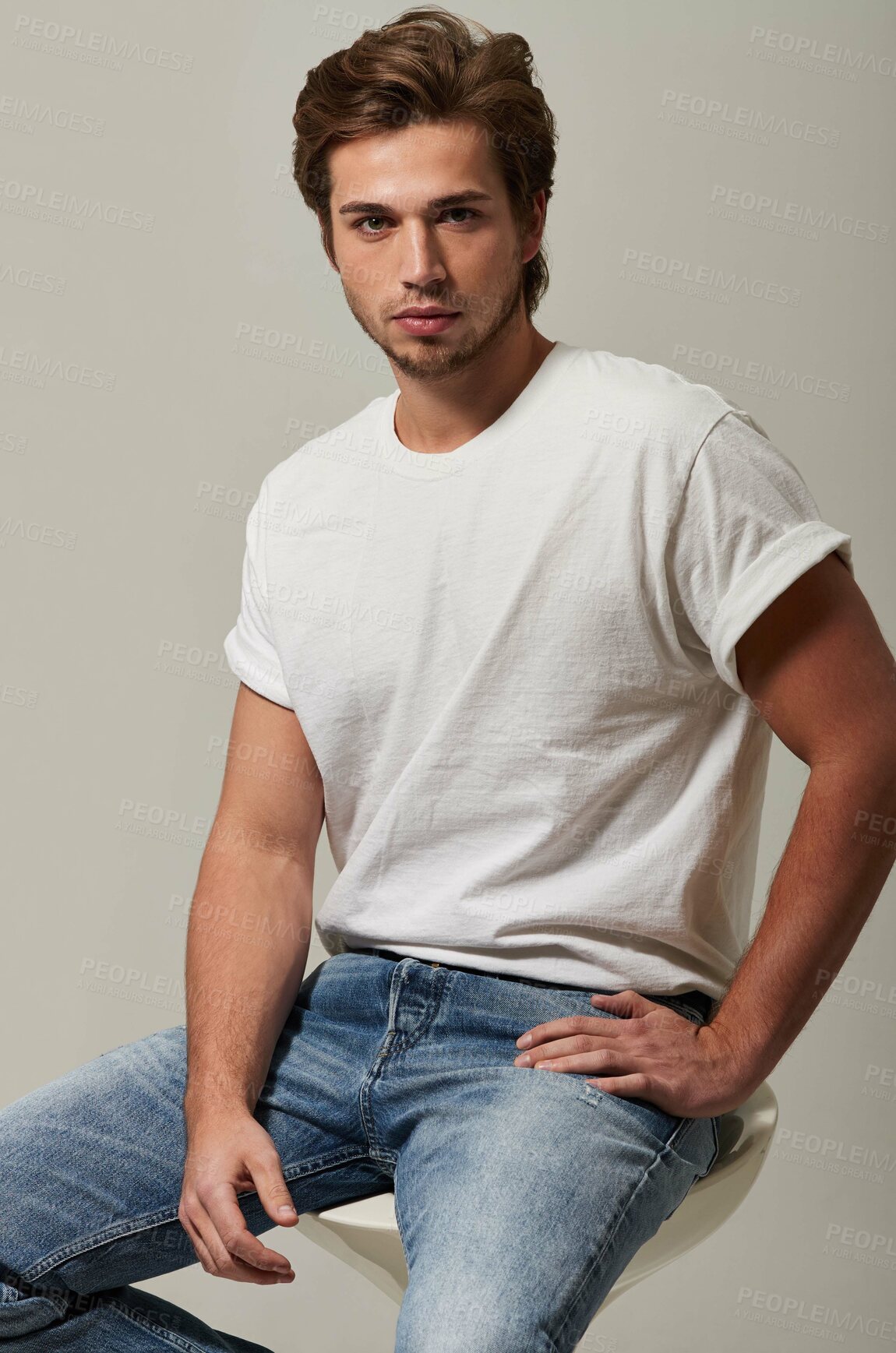 Buy stock photo Serious, fashion and portrait of man on chair in studio isolated on a white background with tattoo. Style, confidence and handsome male model from Sweden in casual clothes, trendy jeans or tshirt.