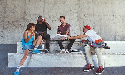 Buy stock photo Shot of a group of skaters having lunch together