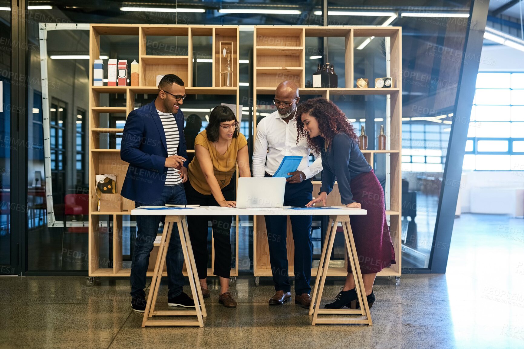 Buy stock photo Shot of a group of designers having a discussion in a modern office