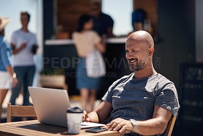 Buy stock photo Cropped shot of a cheerful middle aged man working on his laptop next to a coffee truck outside during the day