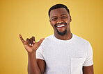 Man, shaka sign and studio portrait for smile, excited and symbol for review, vote and like by yellow background. Happy African person, hand and emoji for feedback, choice and decision with gesture