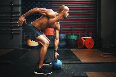Buy stock photo Fitness, weightlifting and black man with kettlebell in gym training for competition, health and body wellness. Sports, workout and exercise, African American athlete lifting with power and strength.