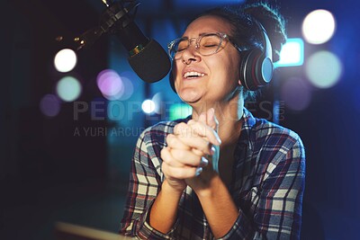 Buy stock photo Radio DJ, headphones and microphone, woman is excited with singing or talking, broadcast media and announcement. Female in studio booth, recording and happiness with smile, excitement and carefree