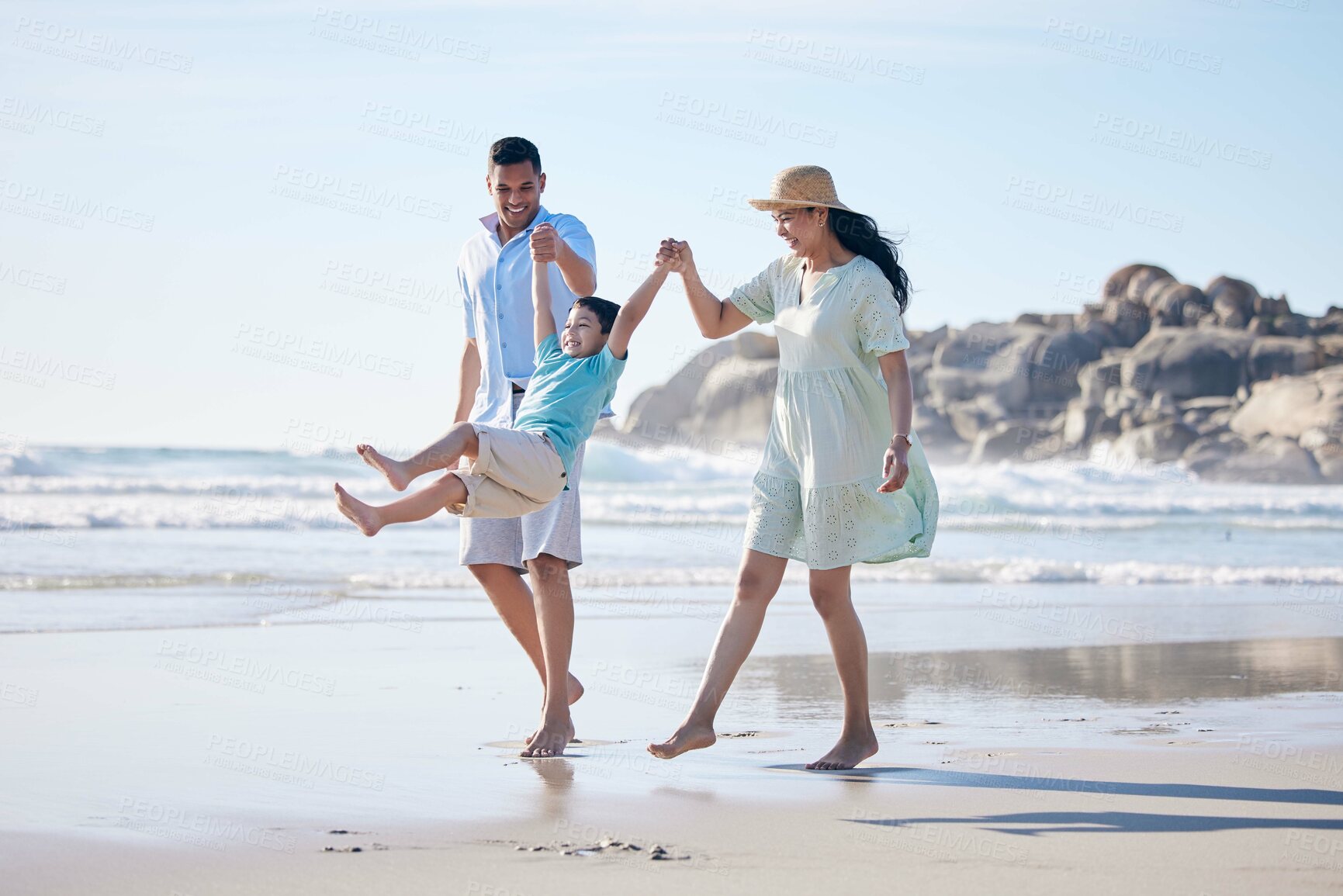 Buy stock photo Family, mother and father with a child at the beach for fun, adventure and play on holiday. A happy woman, man and young kid walking on sand or swinging on vacation at the ocean, nature or outdoor