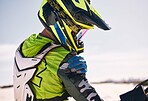 Race, ready and a man on a bike on sand for a competition, travel or adrenaline rush in sport. Helmet, vacation and a person or professional moto driver in the desert for adventure or action