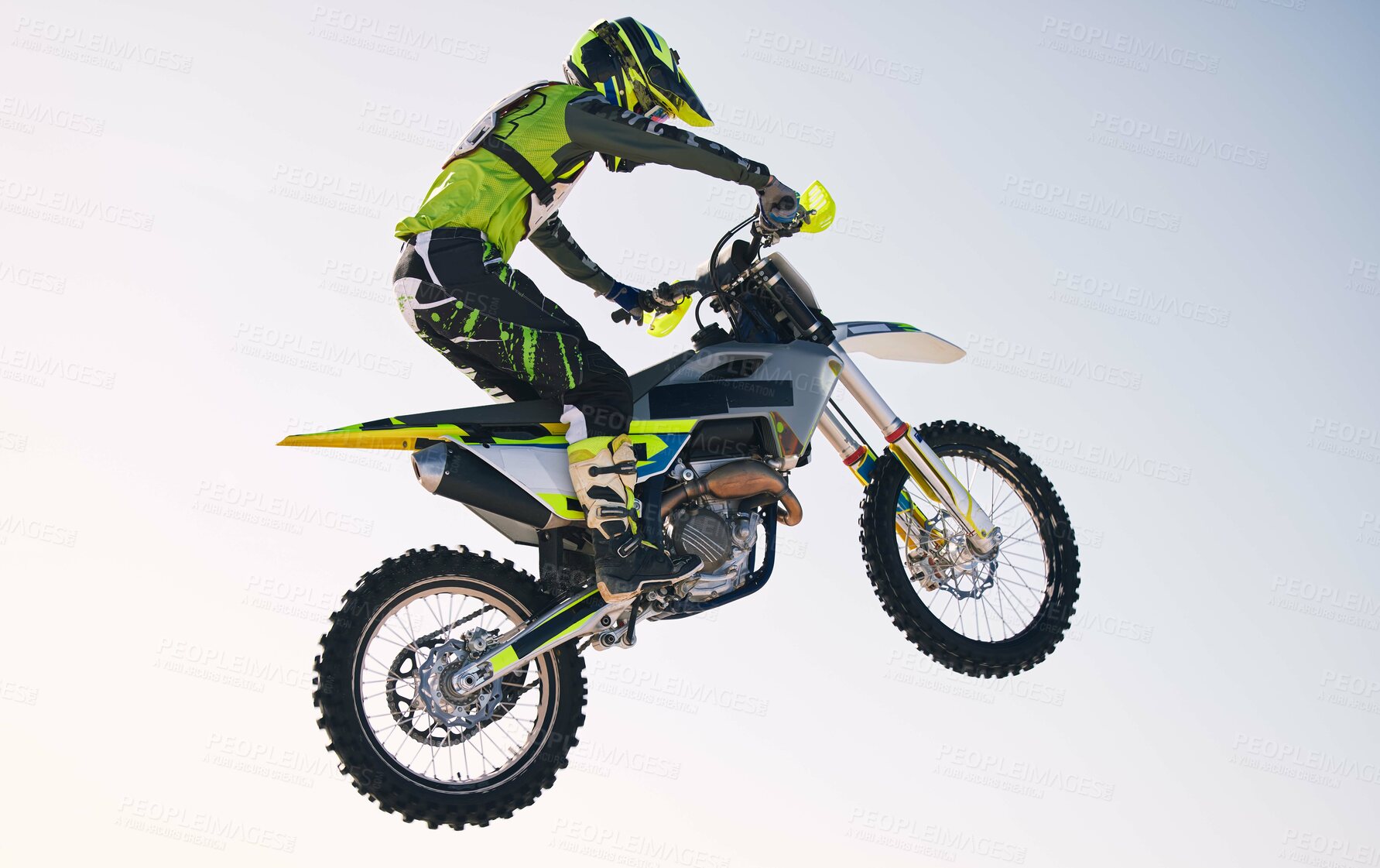 Buy stock photo Jump, adventure and man on motorbike with blue sky for practice, training and extreme sports energy. Professional dirt biking challenge, person and danger with off road motorcycle stunt competition.