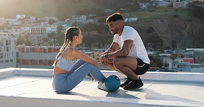 Buy stock photo Fitness, couple and outdoor to talk and rest for exercise, workout or training together on a city rooftop. Happy man and woman on sports break with medicine ball, communication and coach in Cape Town