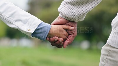 Buy stock photo Holding hands, closeup and park with father, child and walking with bonding, love and security in nature. Dad, kid and safety with trust, care and support for holiday, freedom or adventure together