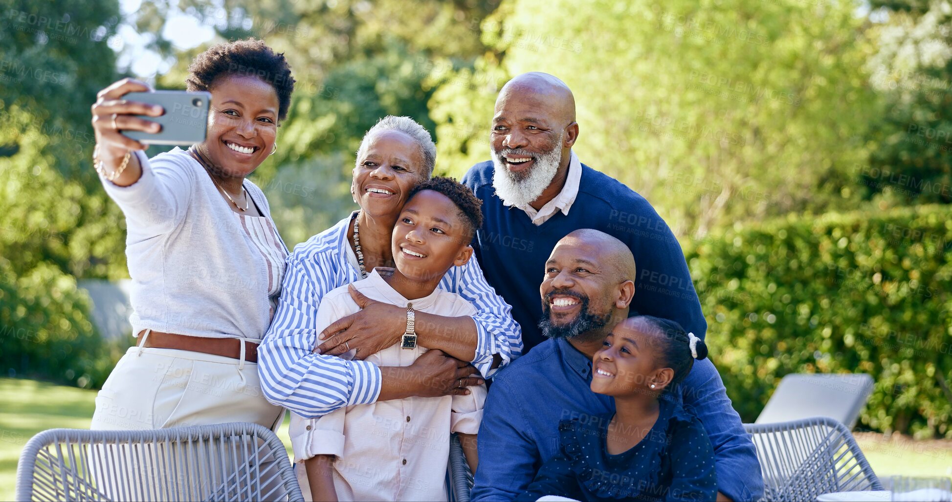 Buy stock photo Happy family, selfie or generations in nature, summer vacation or memory together with love. Black people, grandparents, parents or kids smile on face, garden chairs or smartphone to post online