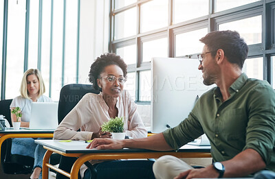 Buy stock photo Shot of two designers having a conversation in a office