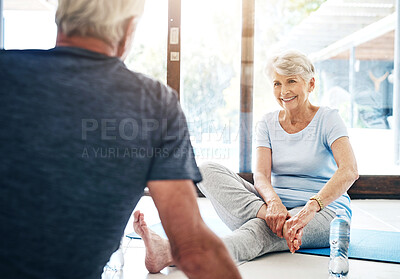 Buy stock photo Shot of a senior couple taking a break while doing yoga together at home
