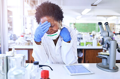 Buy stock photo Shot of a female scientist looking stressed out while working in a lab