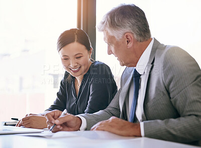 Buy stock photo Shot of a team of businesspeople meeting at a table in the boardroom