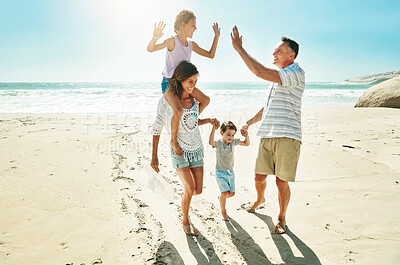 Buy stock photo Parents, children and beach for high five happy or summer travel vacation, ocean sunshine or family development. Man, woman and kids on sand for holiday relax walking or outdoor, clean air or smile