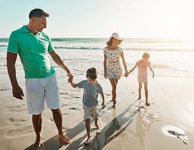 Buy stock photo Parents, children and beach or holding hands for happy summer or travel, ocean sunshine or sibling development. Man, woman and kids on sand for holiday relax walking or outdoor, clean air or vacation