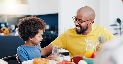 Buy stock photo Black family, food and father with child for breakfast, lunch and eating together in home. Happy, talking and dad and boy at table for bonding with meal for health, nutrition and hunger in house