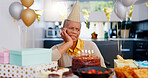 Birthday, thinking and sad senior woman with depression, grief and lonely in her home. Cake, face and elderly African person alone at a party with disappointment, frustrated or annoyed in a house