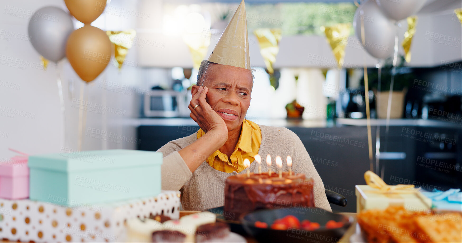 Buy stock photo Birthday, thinking and sad senior woman with depression, grief and lonely in her home. Cake, face and elderly African person alone at a party with disappointment, frustrated or annoyed in a house