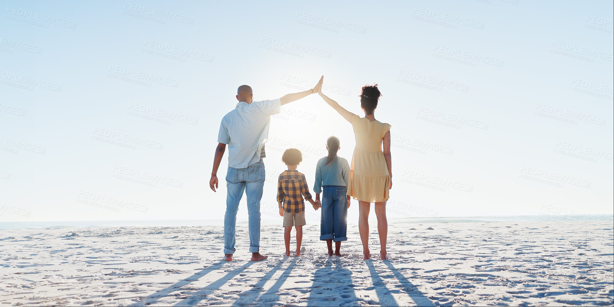 Buy stock photo Back, high five or insurance with a family on the beach together for security, travel or vacation. Flare, safety or cover with a mother, father and children on the sand by the ocean or sea for trust