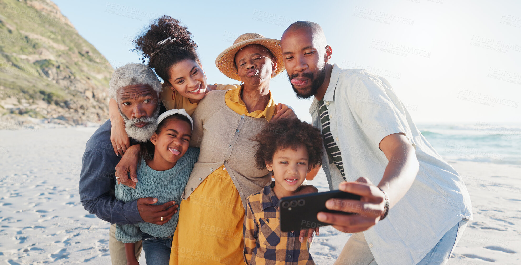 Buy stock photo Selfie, hug and happy family at a beach for travel, fun or adventure in nature together. Love, profile picture and African kids with parents and grandparents at the sea for summer, vacation or trip